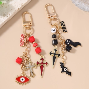 Gothic Halloween beaded keychains with cross, bat, and evil eye charms in red and black