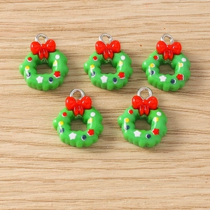 Detail of green Christmas wreath charms with red bows and colorful dots for DIY jewelry