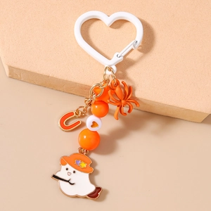 Detail of Halloween keychain featuring ghost, orange spider, and U letter charm