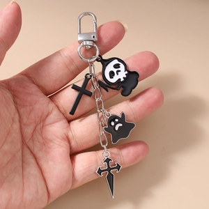 Detail of Gothic keychain featuring grim reaper, ghost, and cross charms on metal chain