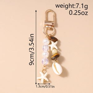 Starfish keychain with dimensions 9cm by 1.3cm and weight of 7.1g on beige background