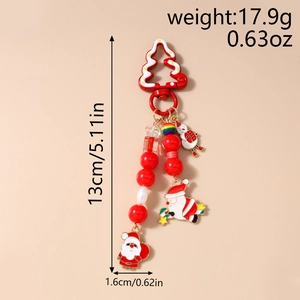 Détail d'un porte-clés de Noël de 13 cm avec perles et breloques de Père Noël et bonhomme