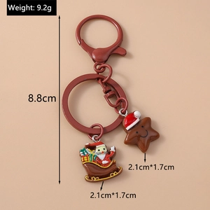 Detail view of Christmas keychain featuring Santa Claus and star pendants with dimensions