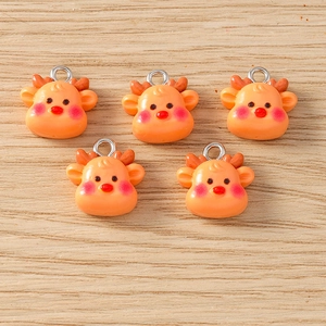 Detailed view of five cute orange resin reindeer charms with silver metal rings for DIY jewelry