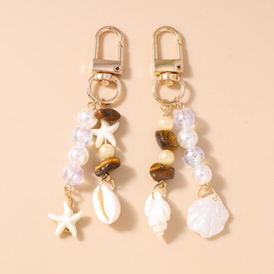 Marine style keychain set with starfish shell charms and pearlescent beads in gold finish