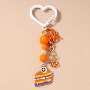 Detail of Halloween keychain with spider charm, eye cake pendant, and heart hook