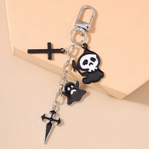 Detail view of Halloween keychain with black enamel reaper, ghost and cross charms