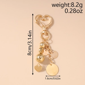 Détail du porte-clés cœur doré avec dimensions 8cm de hauteur et spécifications de 8.2g