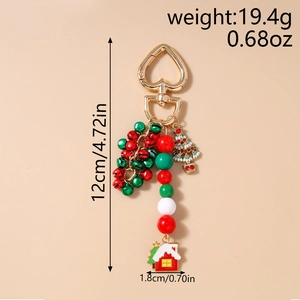 Detailed view of Christmas keychain with colorful bells and enamel charms on gold heart clasp