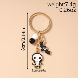 Detailed view of Halloween keychain featuring bat and skull charms with size measurements