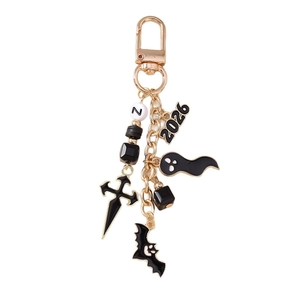 Halloween keychain with golden cross, bat, ghost charms and black beads on white background