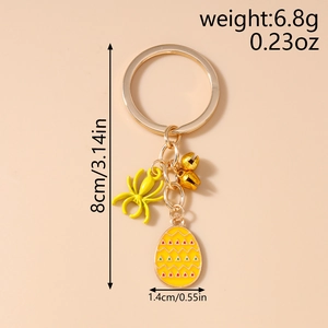 Detail view of yellow spider and enamel egg keychain with size 8cm and weight 6.8g