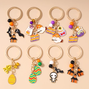 Detailed set of 8 Halloween keychains featuring ghosts bats and haunted house motifs