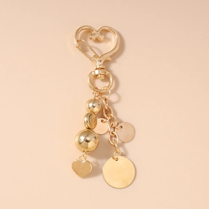 Porte-clés perlé doré à la mode avec pendentif cœur et paillette ronde pour sacs