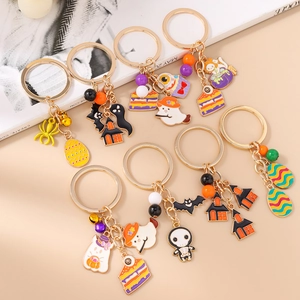 Halloween enamel keychains with ghost, bat and skull charms on a golden metal ring