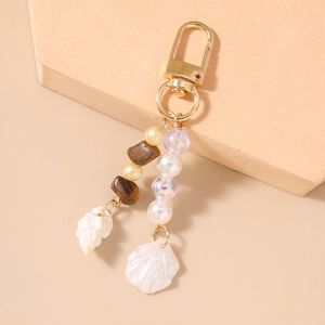 Detailed shot of bohemian keychain with starfish shells and tiger eye stone beads