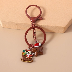 Detail of Christmas keychain with Santa Claus sleigh and gingerbread star pendants