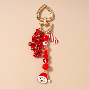 Detail of Christmas keychain with red bells, Santa charm, and golden heart hook