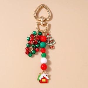 Close-up of Christmas keychain with red green bells and enamel tree on gold clasp