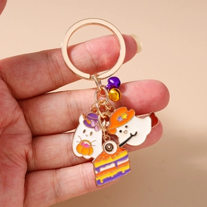 Detail of Halloween keychain featuring ghosts, pumpkin lantern, and eyeball cake charms