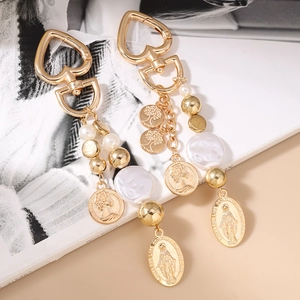 Vintage gold keychain with pearls and embossed portrait charms in a layered design
