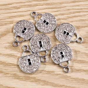Detail of silver pendants with rhinestones and black accents for jewelry making