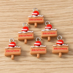 Detail showing resin Christmas signpost charms with red Santa hats and silver loops
