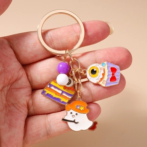 Detail of Halloween keychain with enamel ghosts, spooky cakes and eyeball pendants