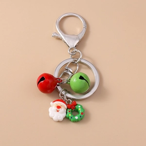 Detail of Christmas keychain with Santa charm, green wreath, and small metal bells