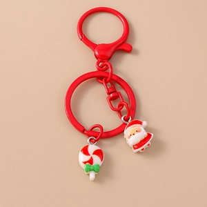 Detail of Christmas keychain with Santa Claus charm and festive candy cane ornament