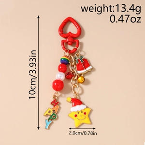 Detail of Christmas keychain with red bells, heart clasp and yellow happy star charm