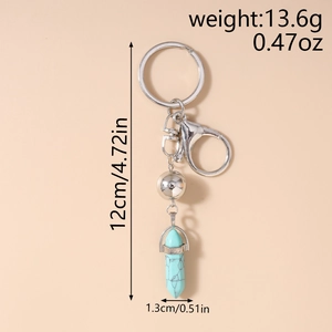 Vue détaillée d'un porte-clés pendentif turquoise avec mesures en centimètres et pouces