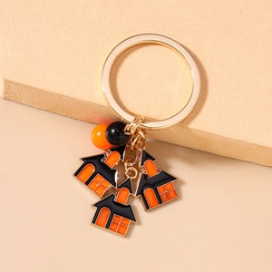 Detail of Halloween keychain with orange and black house charms and decorative beads