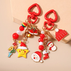 Detail of Christmas keychains featuring Santa Claus charms and colorful beaded accents