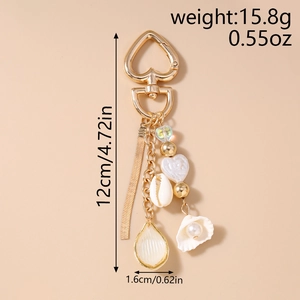 Detail view of gold ocean shell keychain with weight and size specifications info