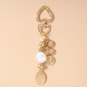 Golden keychain featuring Virgin Mary medal, pearls, tree of life, and coin charms