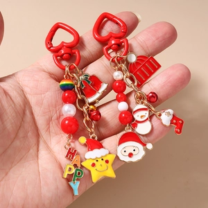 Christmas keychain with Santa Claus, bell and stocking charms on a red heart clasp