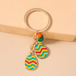 Detailed close-up of colorful wavy pattern egg pendants with golden key ring hardware
