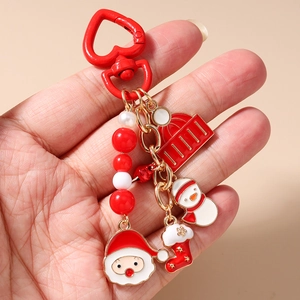 Detail of Christmas keychain with Santa, snowman and red heart spring hook
