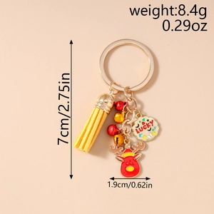 Detailed view of a Christmas reindeer keychain with bells and yellow leather tassel
