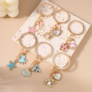 Marine theme keychain set with gold starfish, seahorse and seashell charms
