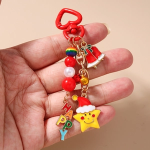 Detail of Christmas keychain with heart carabiner, beads, and Happy letter charms