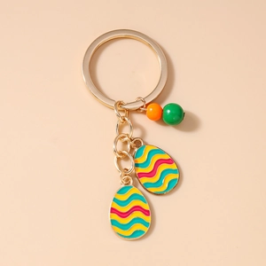 Detail of golden Halloween keychain featuring colorful enamel egg charms and beads