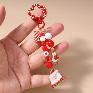 Detail of Christmas keychain with Santa Claus, snowman, and candy cane bead charms
