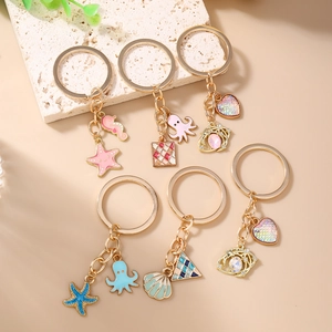 Ocean theme keychain set with gold sea star, seahorse and colorful enamel charms