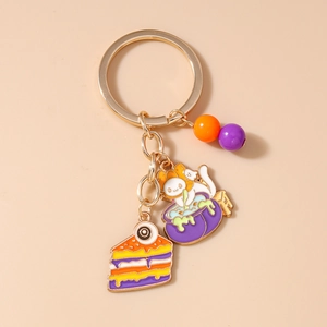 Detail of Halloween enamel keychain with purple cauldron and colorful cake charms