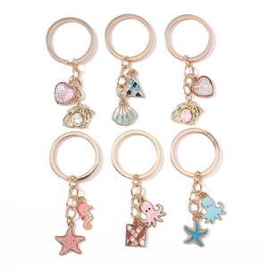 Ocean-themed gold keychains featuring enamel seahorse, starfish and octopus charms