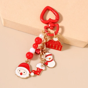 Close-up of Santa Claus and snowman charms on a festive beaded Christmas keychain