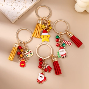 Christmas keychain set with Santa, elk, stars and colorful tassels on beige background
