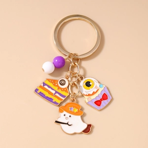 Detail of Halloween keychain charms with ghost, spooky cupcake and gold metal finish